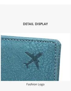 Macro shot of teal travel passport holder featuring white stitching and an airplane logo