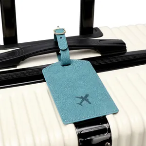 Sky blue PU leather luggage tag with airplane icon on a white suitcase handle