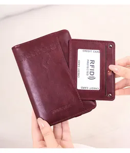 Macro view of burgundy RFID passport holder with secure card slots and aircraft logo
