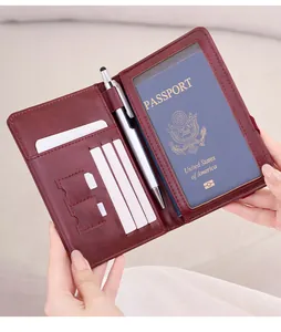 Detail of burgundy RFID passport holder with card slots, SIM pockets and a pen holder