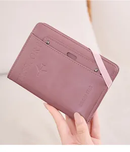 Detail of purple leather RFID passport holder with elastic band and embossed star design