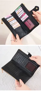 Detail of black pebbled leather wallet showing 10 card slots and gold zipper compartment