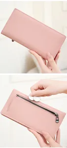 Detail of light pink pebble leather wallet with secure RFID blocking zipper compartment