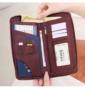 Detail view of burgundy RFID travel wallet featuring multiple card slots and passport pocket