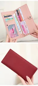 Detail of RFID long wallet showing multiple card slots and leather texture in pink and red