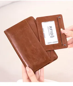 Detail of vintage brown RFID passport holder set with card wallet and airplane embossed cover