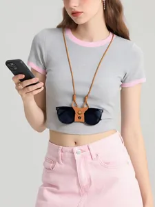 Brown leather magnetic sunglasses holder strap worn by a model against a grey background