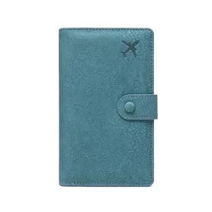 Blue RFID blocking travel passport wallet featuring embossed airplane and snap closure