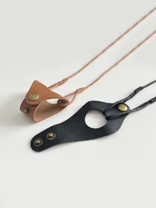 Detailed view of brown and black leather magnetic glasses clips with retro metal snaps