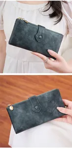 Detail view of slim dark teal long leather wallet with gold zipper and snap button closure