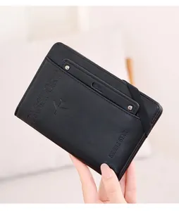 Detail view of black RFID passport holder with elastic band and embossed passport text