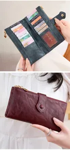 Detail of multi-card long wallet with double zipper and sleek metal buckle closure