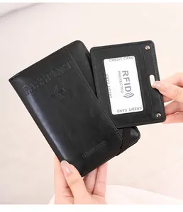 Close-up of black leather passport holder with RFID protection and embossed aircraft logo