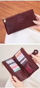 Close-up of burgundy leather wallet with double zippers and multiple card slots detail