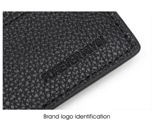 Detail of lychee textured black leather wallet with embossed logo and RFID protection