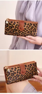 Close-up of leopard print long wallet with double zippers and gold hardware detail