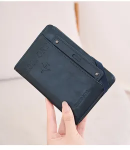 Detail of dark blue RFID passport holder with elastic strap and embossed gold text