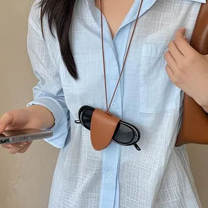 Brown PU leather neck-hanging glasses case with adjustable strap on blue plaid shirt