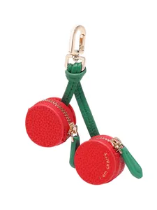 Detail of red cherry fruit coin purse with golden zipper and spring hook attachment
