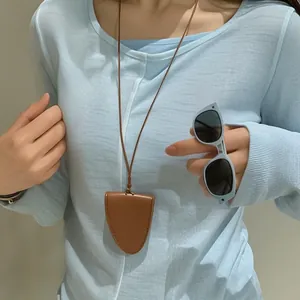 Brown PU leather neck glasses case with blue cat-eye sunglasses on a model wearing blue