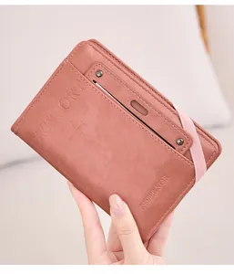 Close-up of pink RFID passport holder with elastic strap and engraved star logo