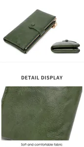 Detail view of green long wallet showing soft pebbled leather texture and dual zip closures