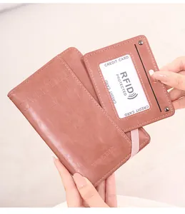 Close-up of pink RFID blocking passport holder with elastic strap and matching ID card cover