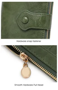 Detail of dark green leather wallet showing hardware snap and smooth golden zipper head
