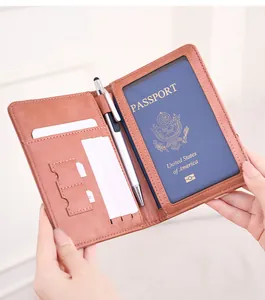 Detail of RFID leather passport wallet showing card slots and pen holder in brown finish