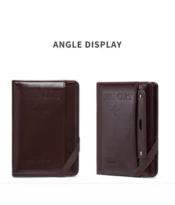 Detail of dark brown leather passport cover with elastic strap and engraved star pattern