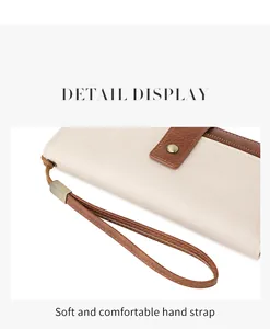 Dettaglio del cinturino da polso in morbida pelle PU beige e hardware in metallo bronzo
