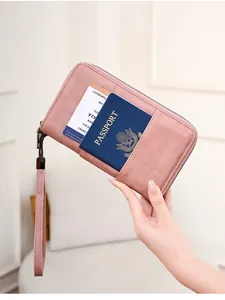 Pink RFID passport wallet with exterior slot holding a boarding pass and travel document