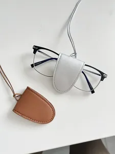 Detail of PU leather glasses cases in brown and silver with fine stitching and neck cords
