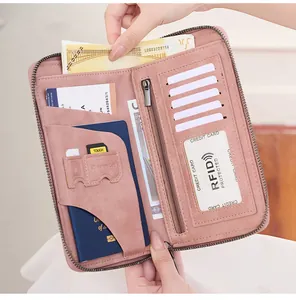 Detail view of pink RFID blocking passport wallet with multi-functional card slots and zipper