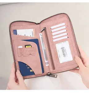 Detailed interior of pink travel wallet showing RFID passport slot and multiple card holders