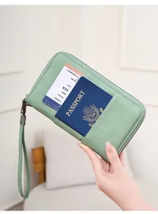 Close-up of mint green RFID passport wallet with litchi texture and wrist strap