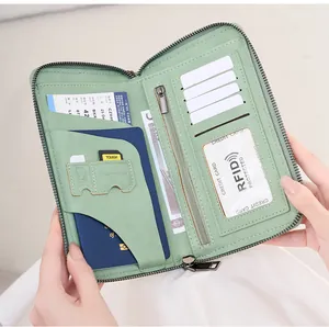 Detailed interior view of a mint green RFID travel passport wallet with multiple card slots