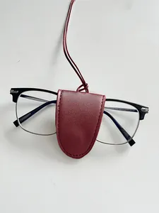 Detail of burgundy leather magnetic eyewear clip with lanyard and neat stitching