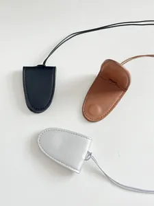 Detailed view of PU leather glasses cases in black, caramel brown and silver finishes