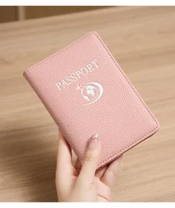 Pink lychee texture RFID passport holder with white aircraft logo on wooden background