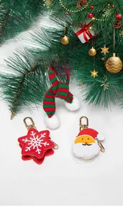 Close-up of festive Santa Claus and red star mini pouches with gold clasps on tree