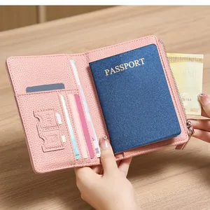 Close-up of pink litchi leather passport holder interior with card slots and money pocket