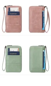 Detail view of RFID travel wallets in pink and green with card slots and wrist strap