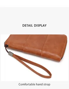 Detail view of the brown leather RFID passport wallet with hand strap and stitching
