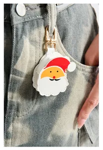 Close-up of cute Santa Claus keychain pendant on camouflage denim pants belt loop