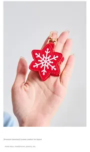 Detail of red leather snowflake coin purse with gold metal clasp for keys and earphones
