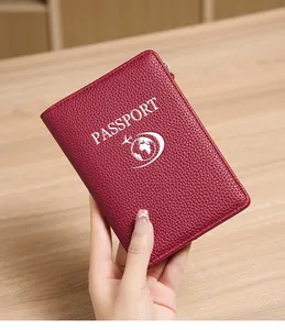 Close-up of burgundy RFID passport holder featuring litchi grain texture and secure zipper