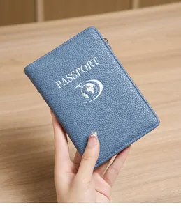 Detail of blue pebble grain leather passport holder with RFID protection and zipper