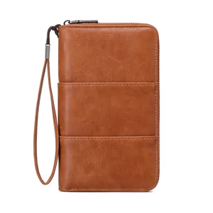 Brown leather RFID passport wallet with zipper closure and wrist strap for travel gear
