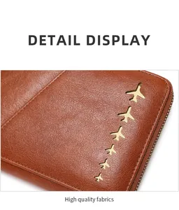 Detail view of brown pebbled leather texture with six golden airplane accents and zipper